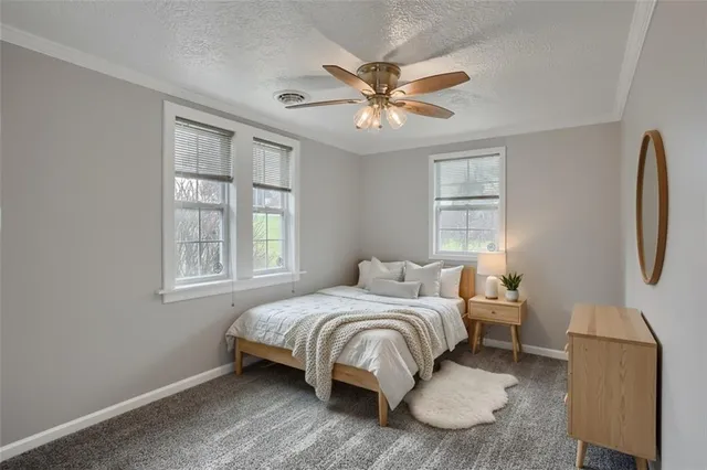 a view of a livingroom with a ceiling fan and window