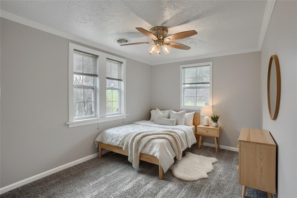 110 Oakville Road Beaver Falls, PA 15010 - Photo 31 of 48 a bedroom with a bed a chandelier and a window