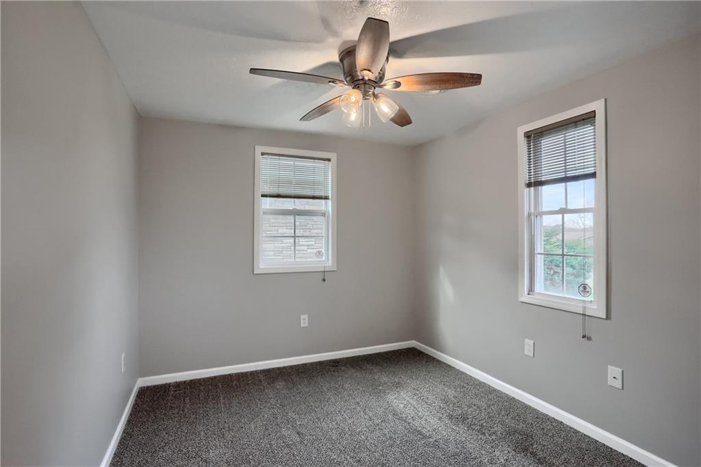 110 Oakville Road Beaver Falls, PA 15010 - Photo 37 of 48 an empty room with windows and fan