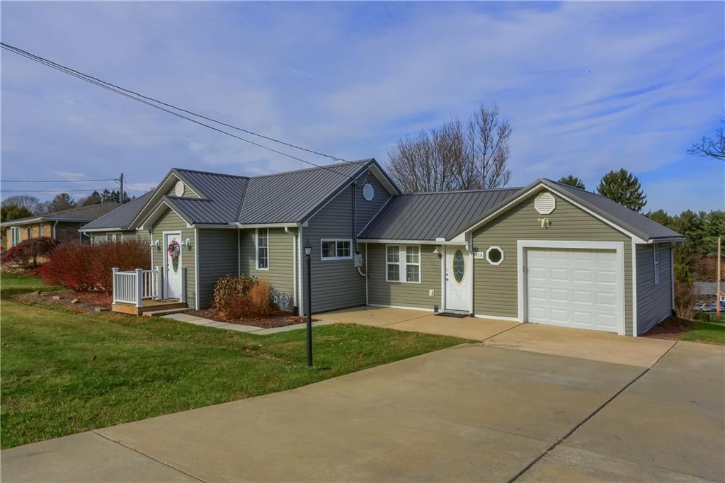 110 Oakville Road Beaver Falls, PA 15010 - Photo 4 of 48 a front view of a house with a yard and garage