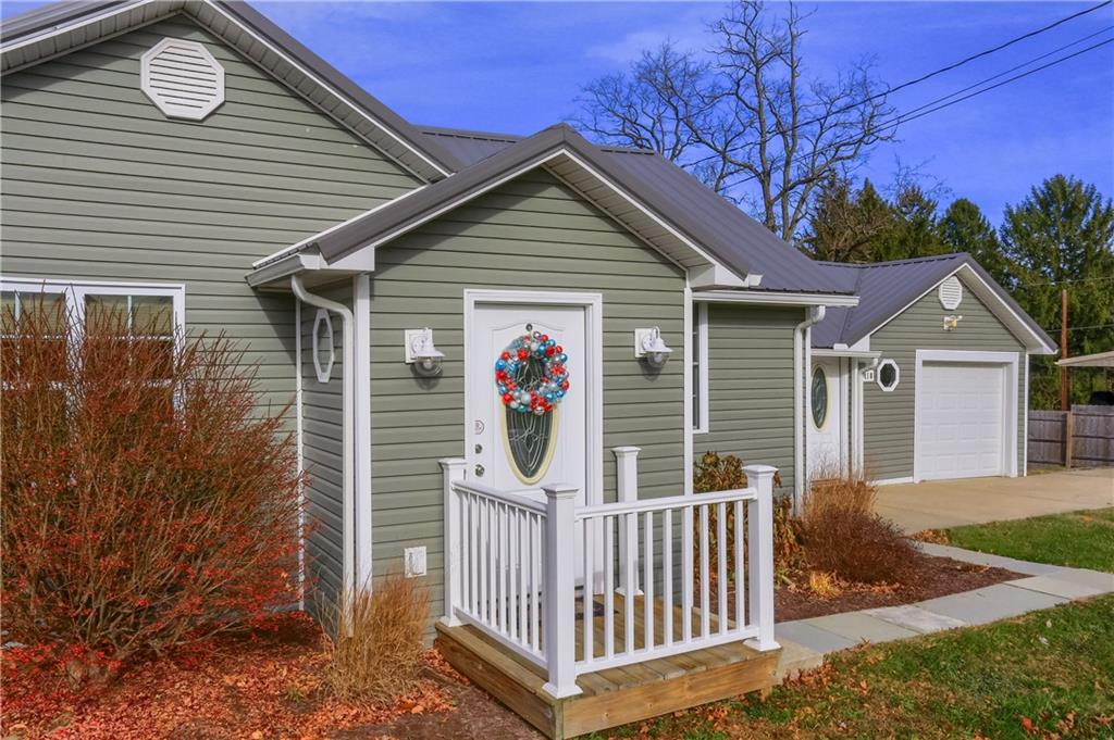 110 Oakville Road Beaver Falls, PA 15010 - Photo 5 of 48 a view of a small house with wooden fence and large trees