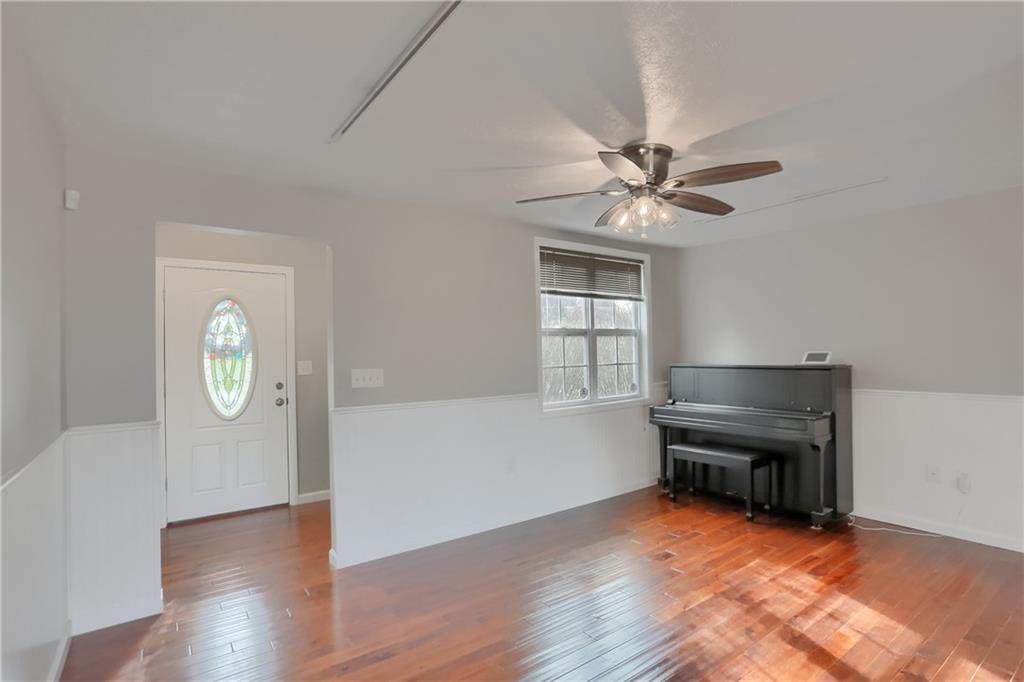 110 Oakville Road Beaver Falls, PA 15010 - Photo 7 of 48 an empty room with windows and a chandelier fan