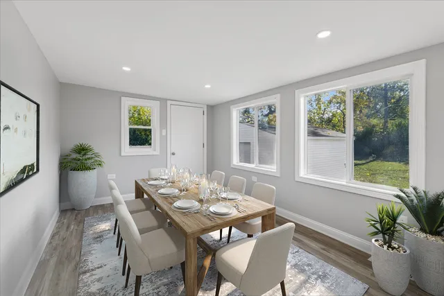 a view of a dining room with furniture window and wooden floor