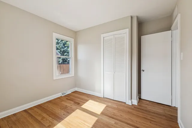 a view of a room with wooden floor and closet