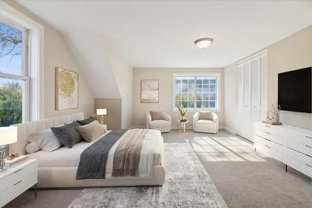 a bedroom with a large bed and a flat screen tv