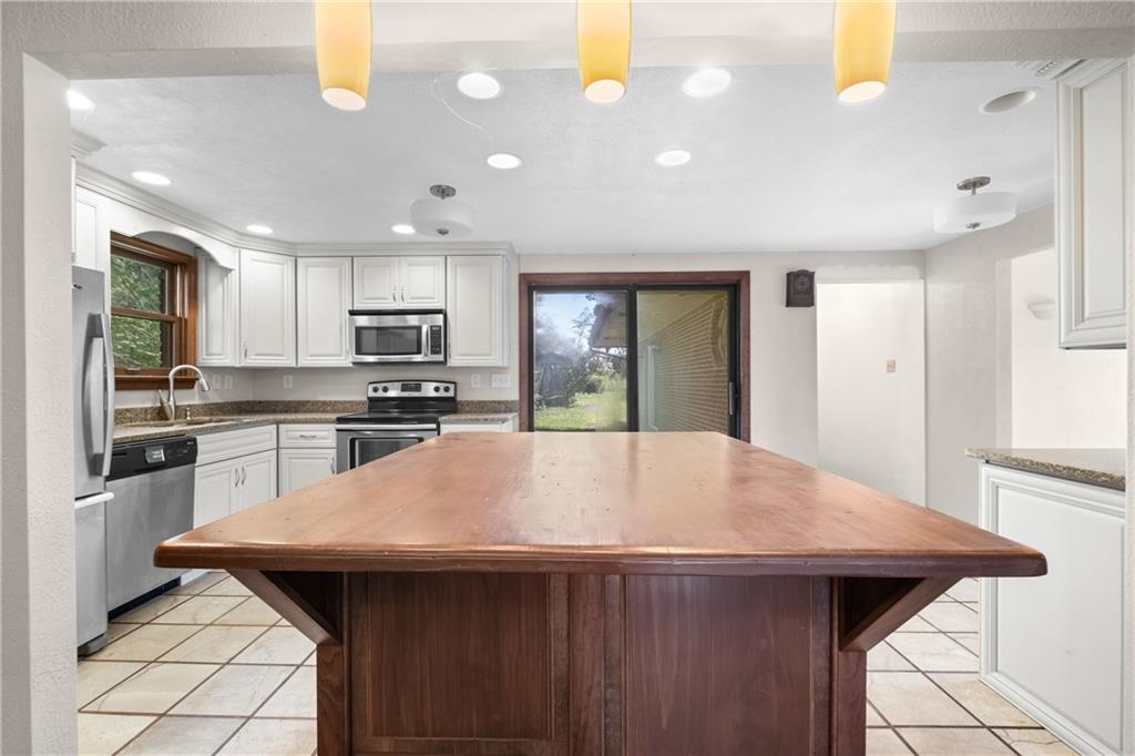 1003 Beacon Way Pittsburgh, PA 15241 - Photo 11 of 45 a kitchen with kitchen island a sink stainless steel appliances and window