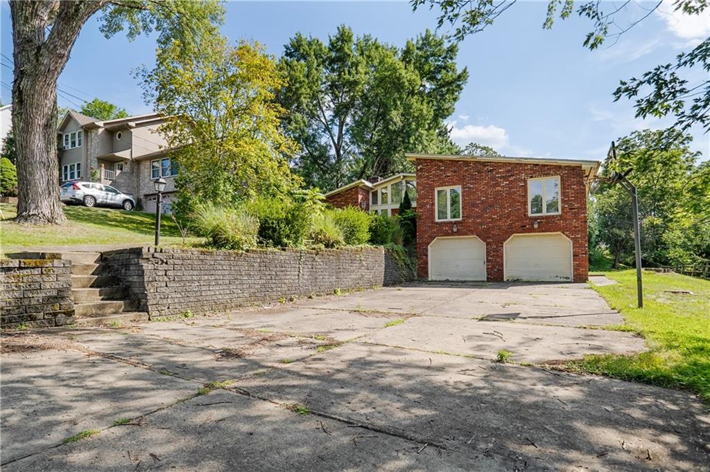 1003 Beacon Way Pittsburgh, PA 15241 - Photo 2 of 45 a front view of a house with a yard and garage