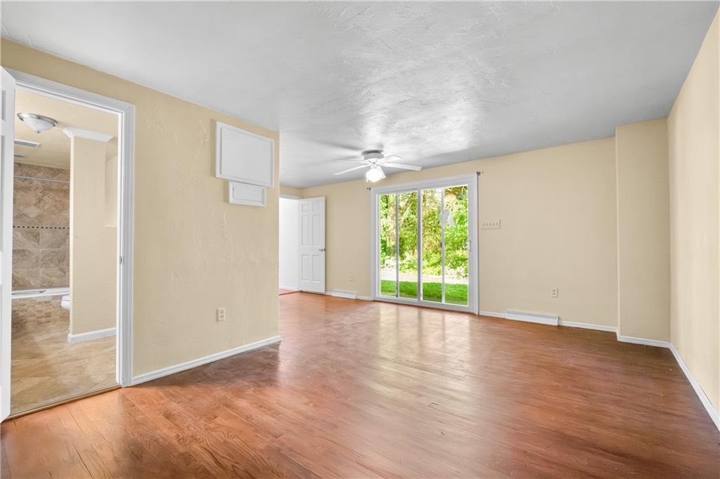 1003 Beacon Way Pittsburgh, PA 15241 - Photo 22 of 45 a view of an empty room with wooden floor and a window