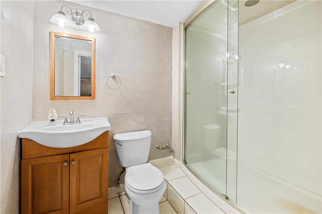 1003 Beacon Way Pittsburgh, PA 15241 - Photo 32 of 45 a bathroom with a toilet sink vanity granite and shower