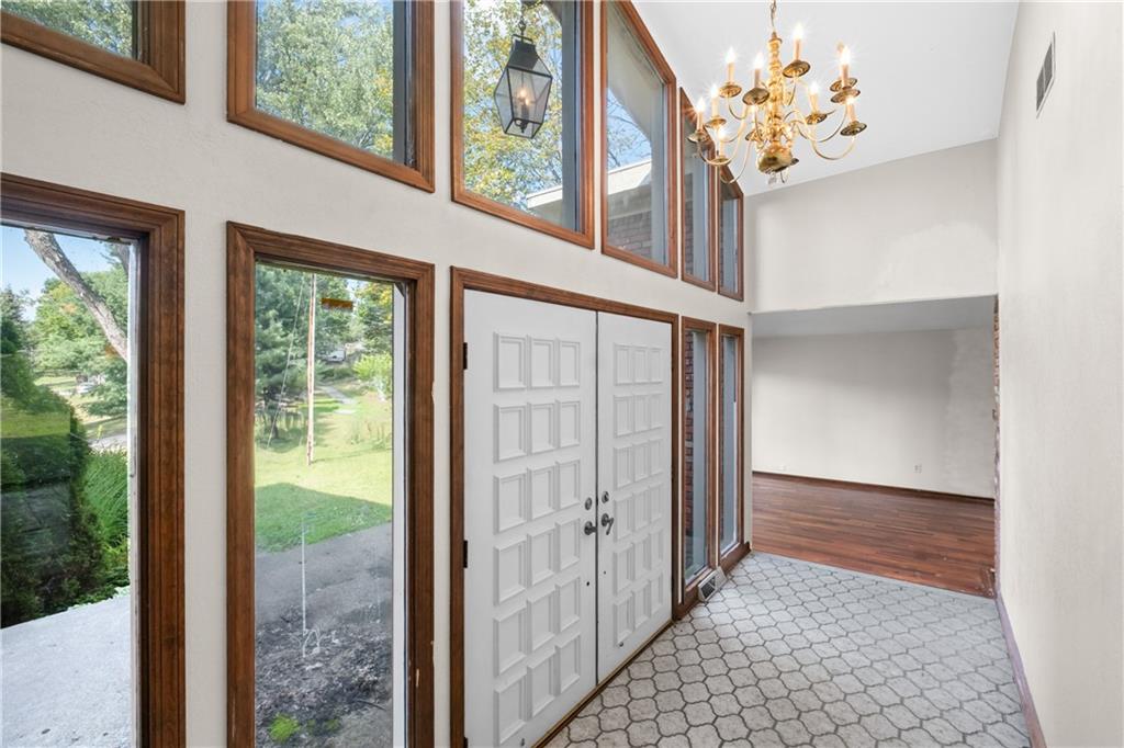 1003 Beacon Way Pittsburgh, PA 15241 - Photo 4 of 45 a view of a hallway with wooden floor and a chandelier