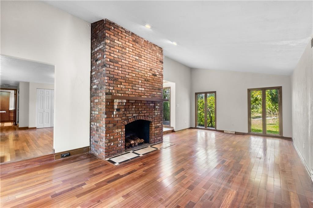 1003 Beacon Way Pittsburgh, PA 15241 - Photo 7 of 45 a view of an empty room with wooden floor fireplace and a window