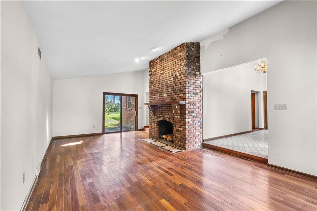 1003 Beacon Way Pittsburgh, PA 15241 - Photo 8 of 45 a view of an empty room with wooden floor fireplace and a window