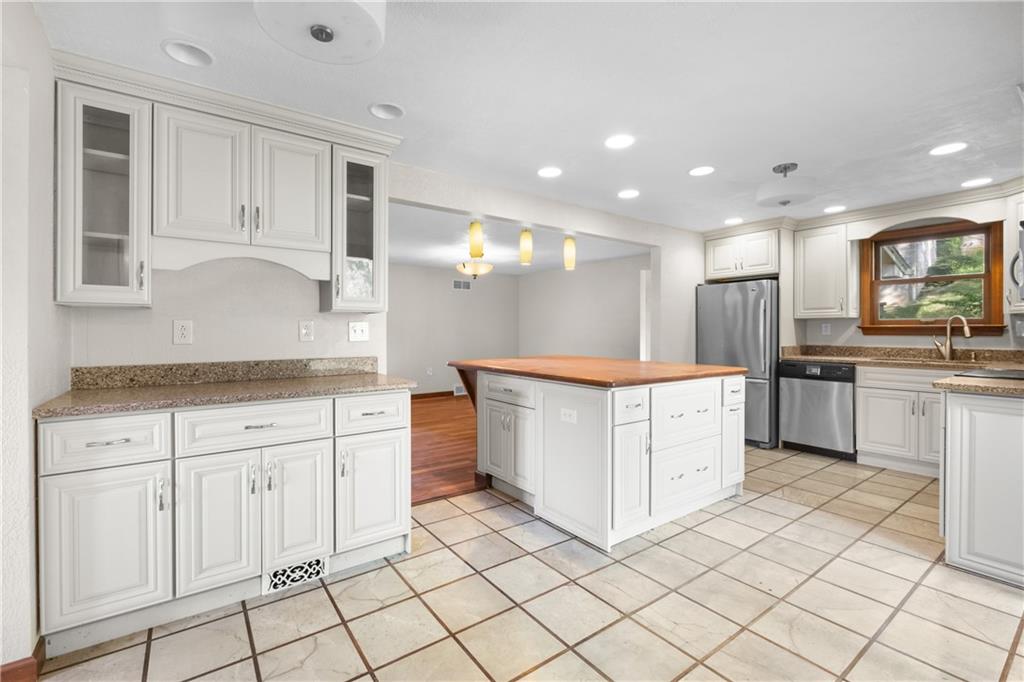 1003 Beacon Way Pittsburgh, PA 15241 - Photo 9 of 45 a open kitchen with granite countertop white cabinets and white appliances