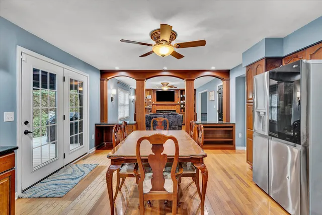 a view of a livingroom with furniture window wooden floor and a ceiling fan