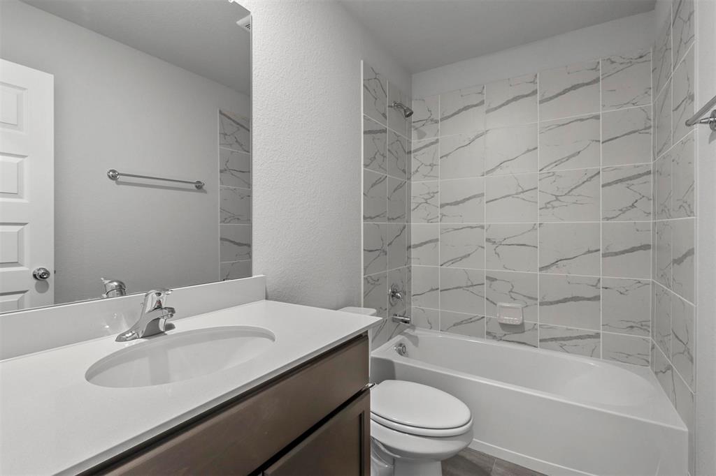 2755 Rambling Road Celina, TX 75009 - Photo 7 of 15 Bathroom featuring a spacious vanity with a white countertop, an integrated sink, and a large wall-mounted mirror