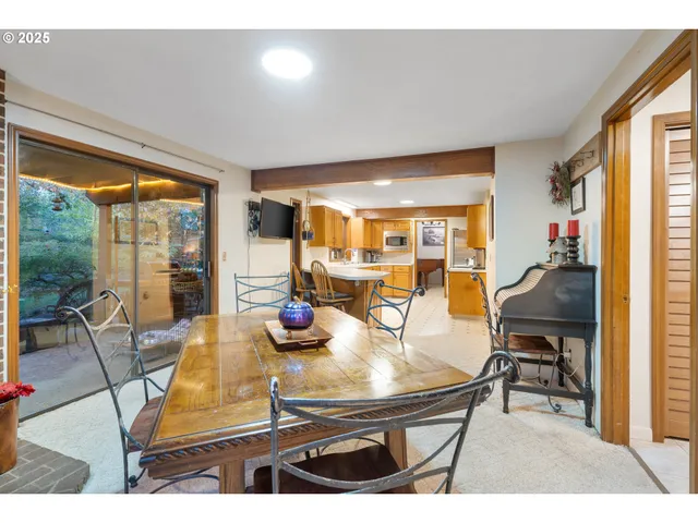 a dining room with furniture and a potted plant