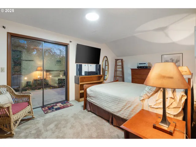 a living room with furniture a rug and a large window
