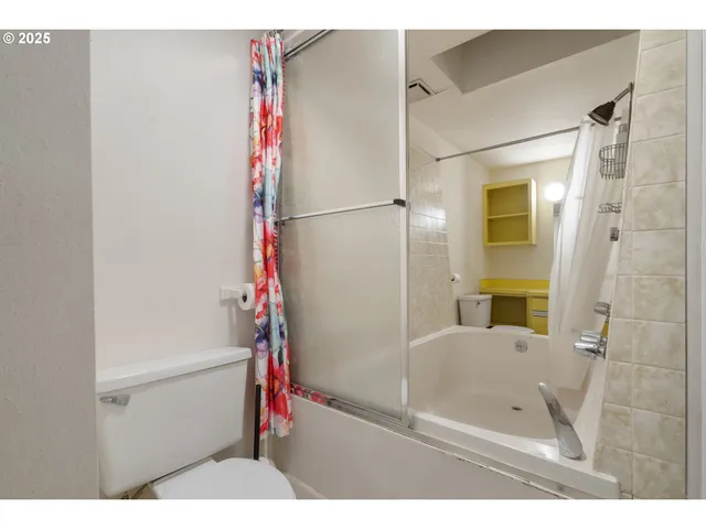 a backyard of a house with barbeque oven table and chairs