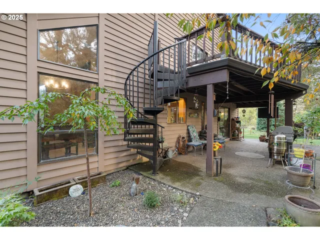 a view of a patio with table and chairs a barbeque