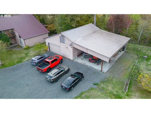 a backyard of a house with barbeque oven table and chairs