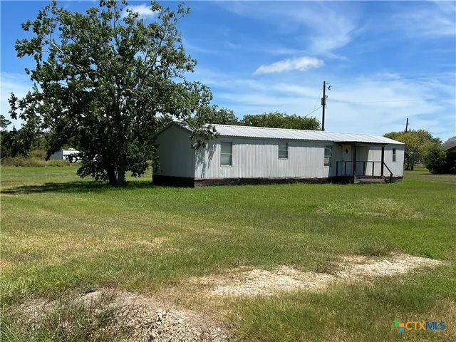 a view of grassy field with trees