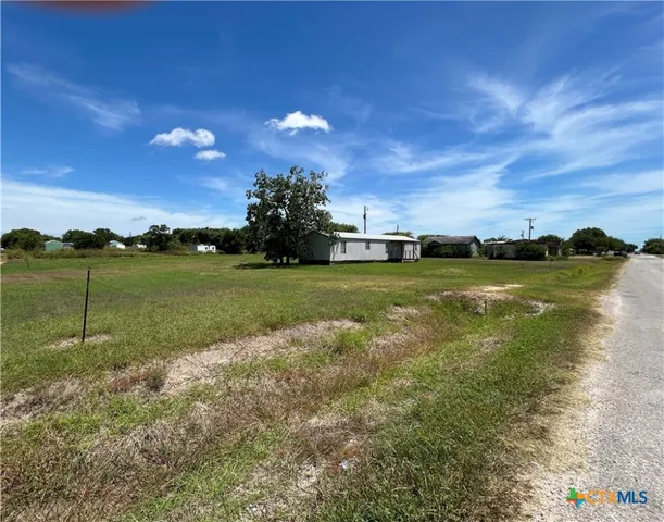 a view of yard with swimming pool and green space