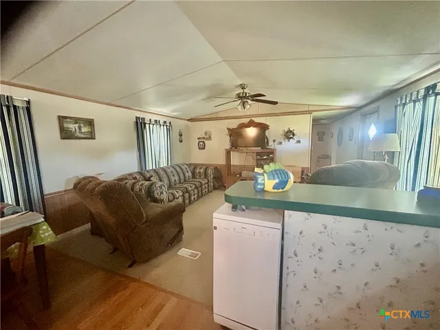 a living room with a couch and chandelier
