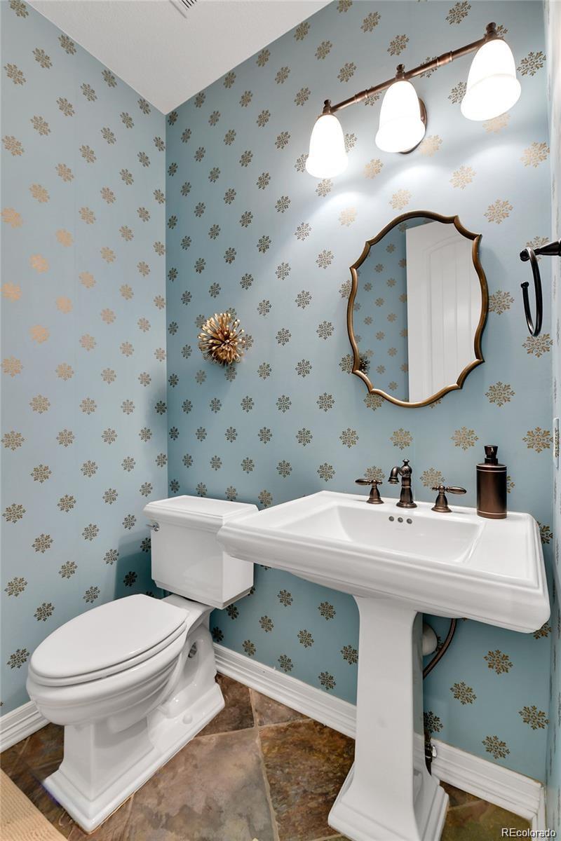 791 Elk Rest Road Evergreen, CO 80439 - Photo 14 of 39 a bathroom with a sink a toilet and a mirror