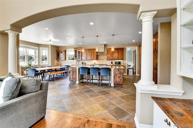 a living room with lots of furniture and a kitchen