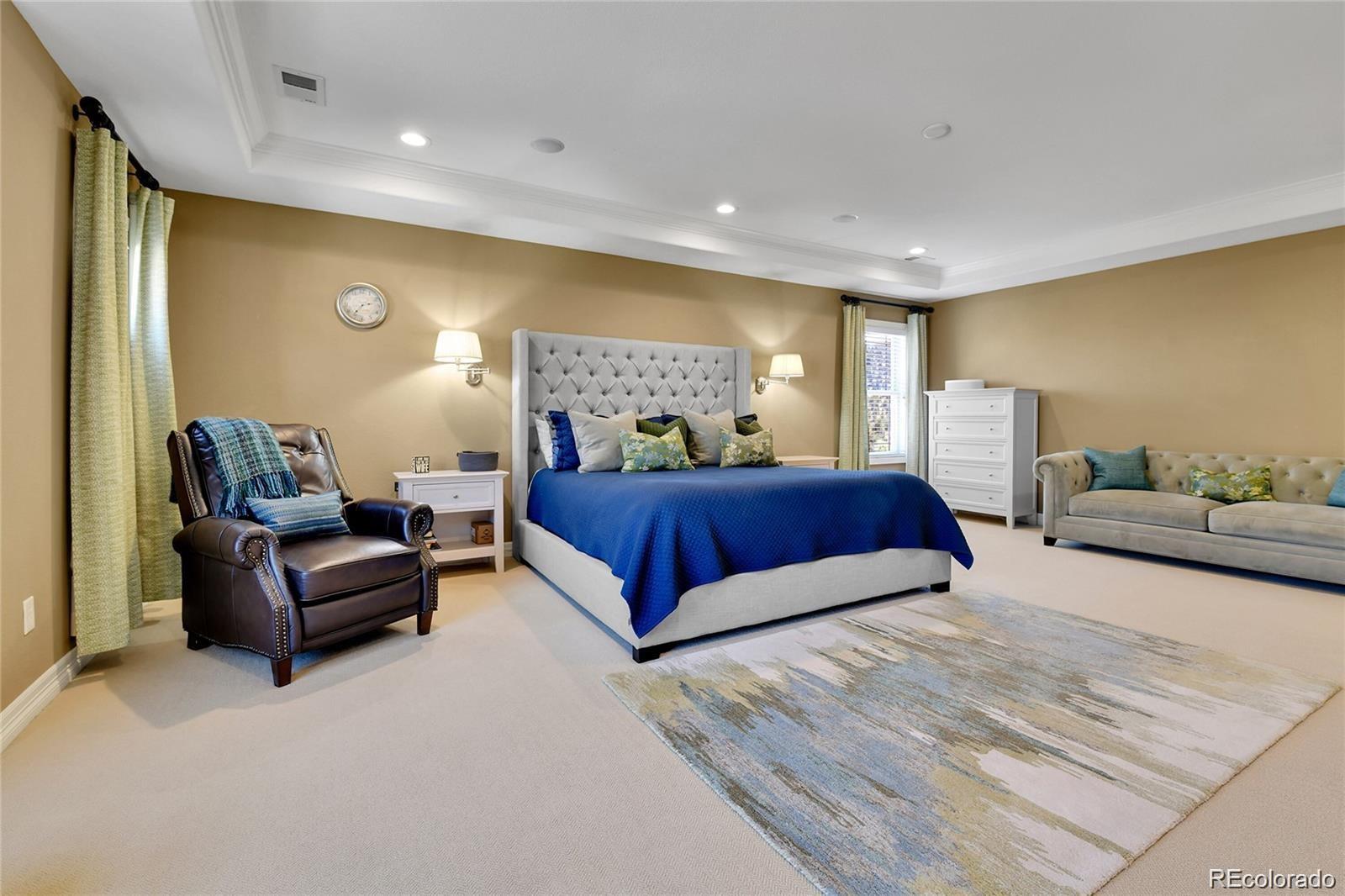 791 Elk Rest Road Evergreen, CO 80439 - Photo 20 of 39 a spacious bedroom with a bed and couch