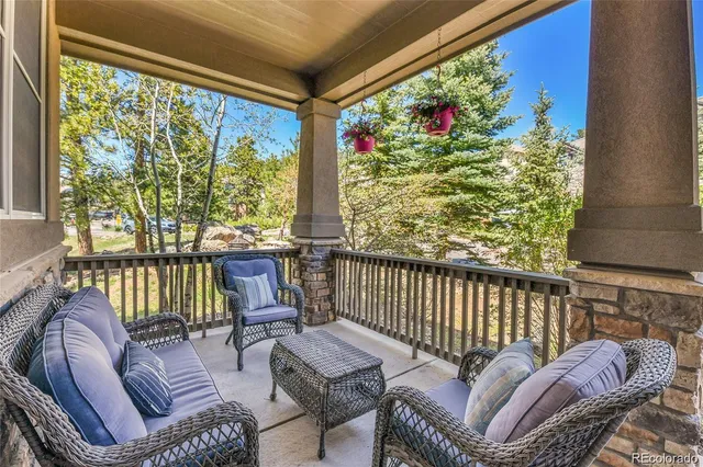 a balcony with furniture and a potted plant