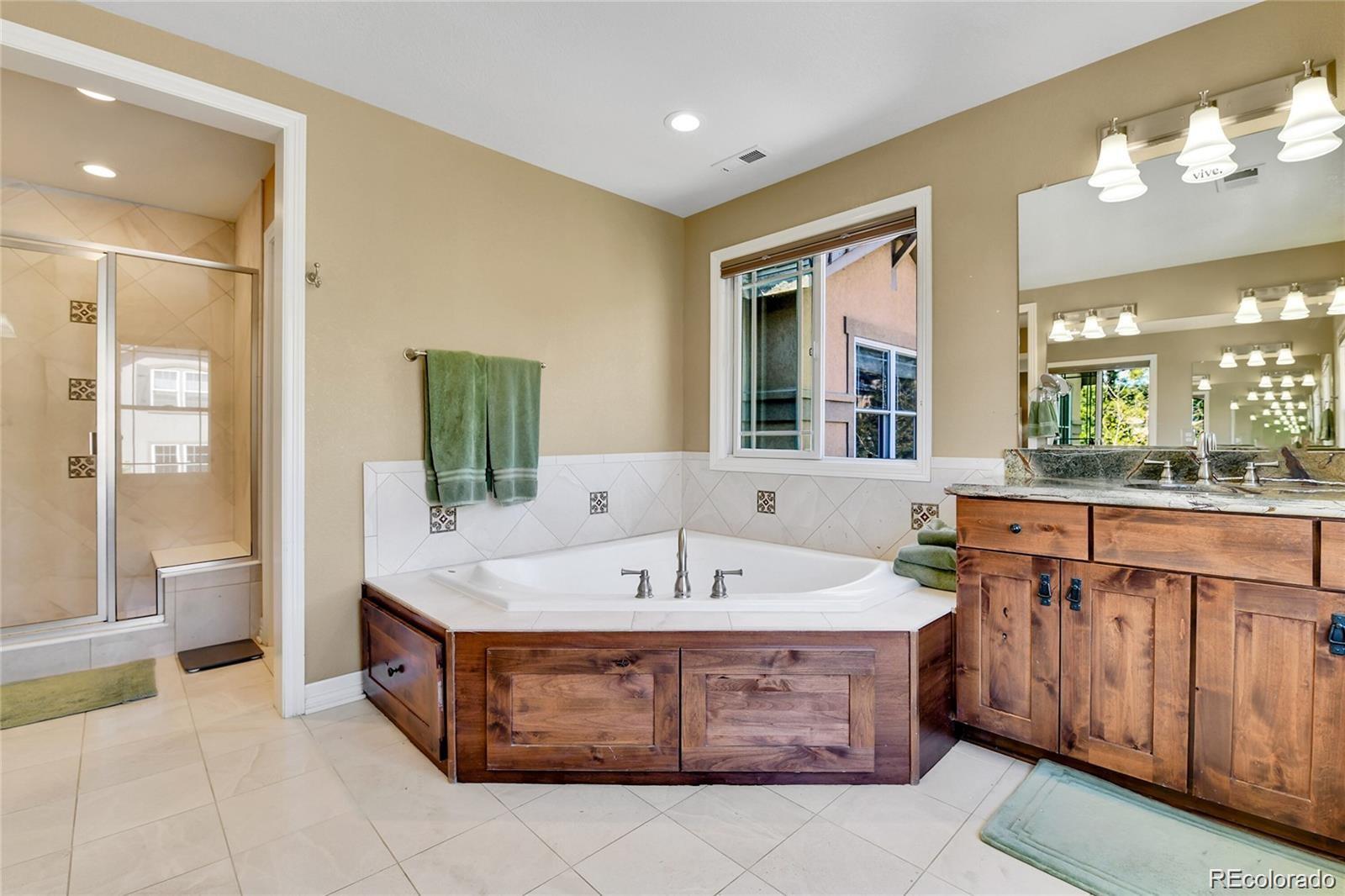 791 Elk Rest Road Evergreen, CO 80439 - Photo 21 of 39 a spacious bathroom with a sink double vanity and a bathtub