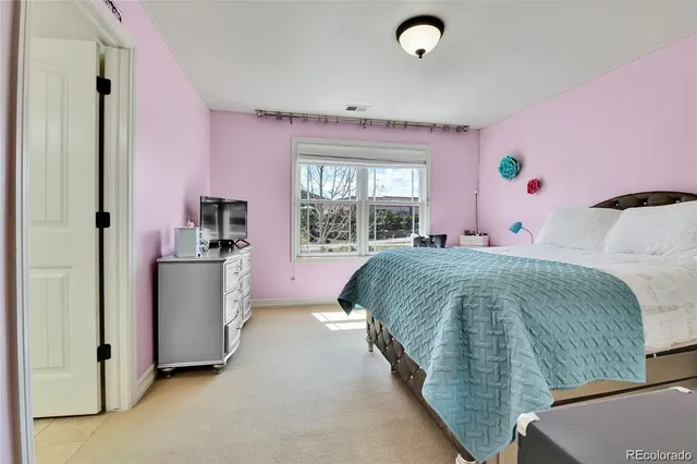 a bedroom with a bed and a large window