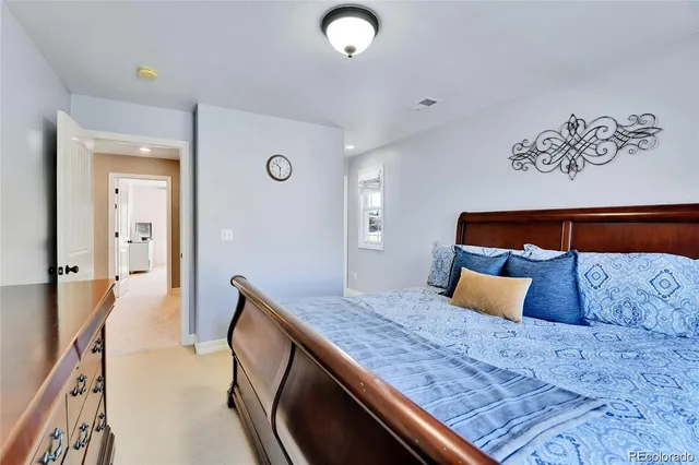 a bedroom with a bed and lamp