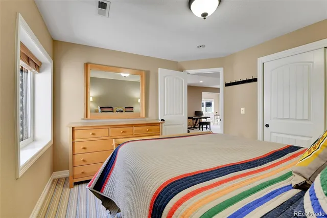 a bedroom with a bed and a dresser