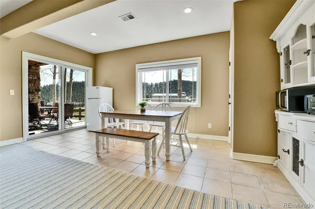 a living room with furniture a large window and wooden floor