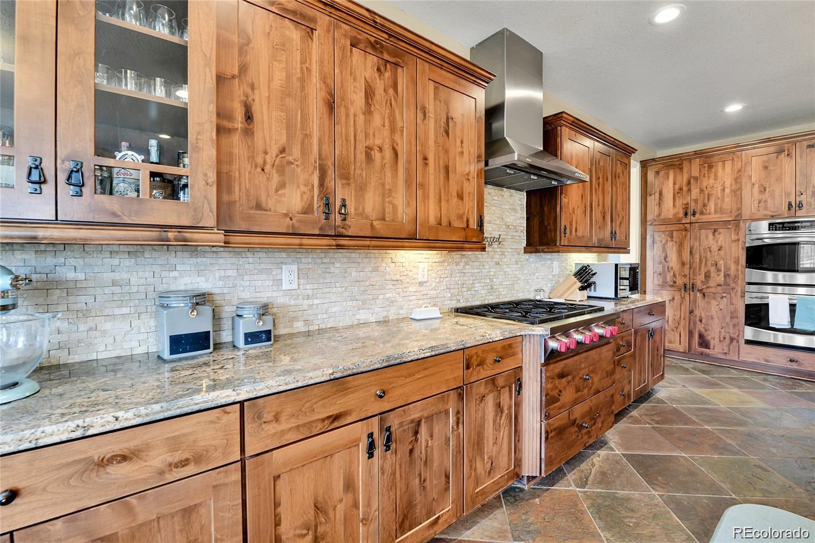 791 Elk Rest Road Evergreen, CO 80439 - Photo 8 of 39 a kitchen with stainless steel appliances granite countertop a stove a sink and a microwave