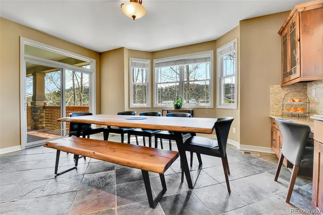 a dining room with furniture and wooden floor