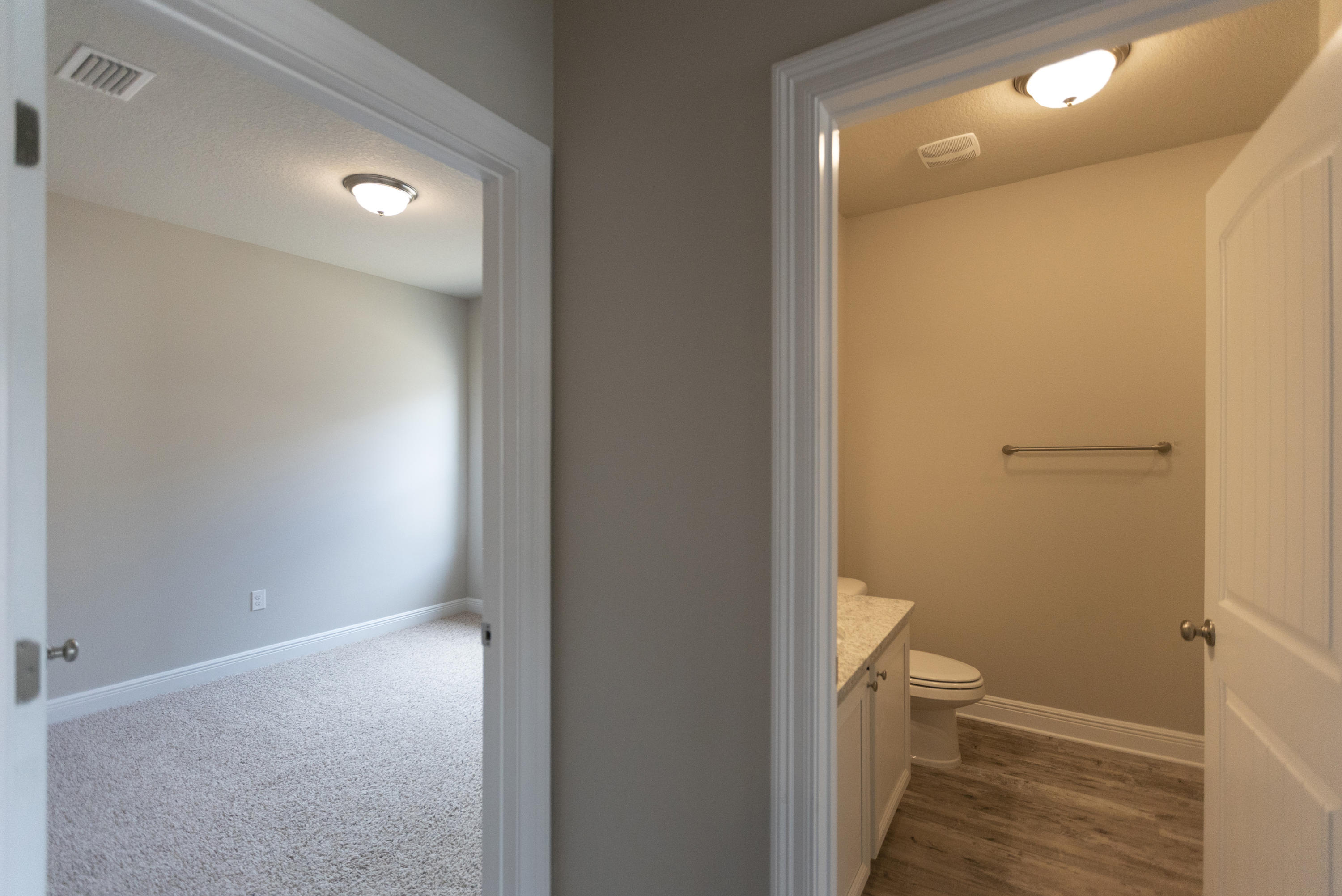 385 Wayne Trail Santa Rosa Beach, FL 32459 - Photo 14 of 39 a bathroom with a granite countertop toilet and a sink