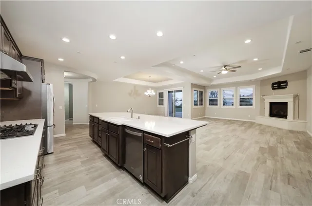 a kitchen with kitchen island a sink counter top space and stainless steel appliances