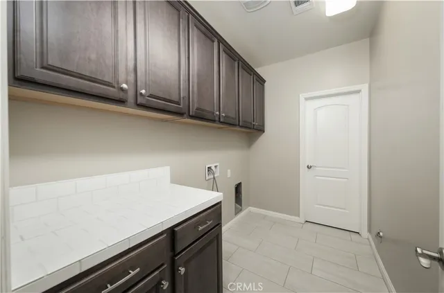 a view of a storage and utility room with a sink