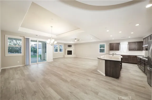 a large white kitchen with a large counter top appliances and cabinets