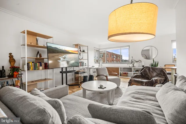 a living room with furniture and a chandelier