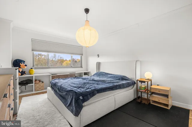 a bed room with a bed and a chandelier