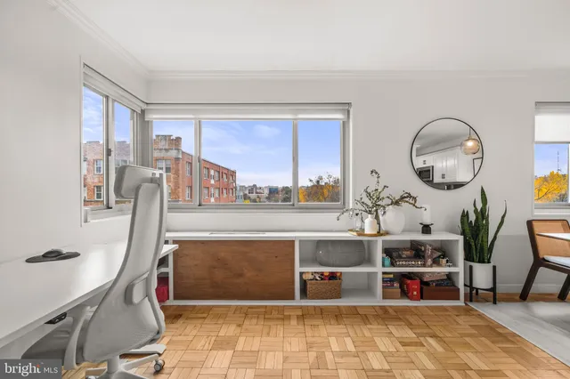 a living room with fireplace furniture and a large window