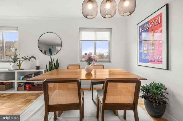 a view of a dining room with furniture and chandelier