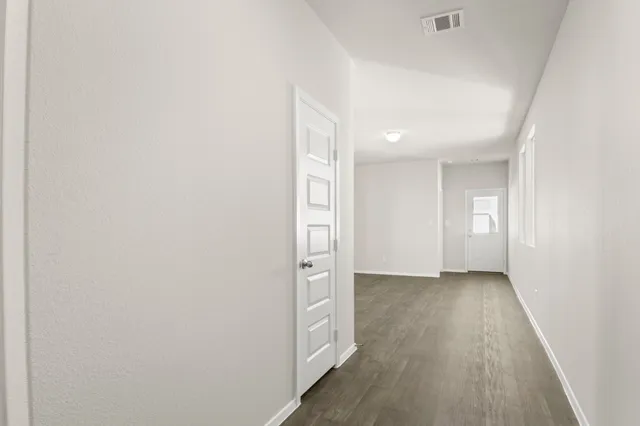 a view of hallway with wooden floor