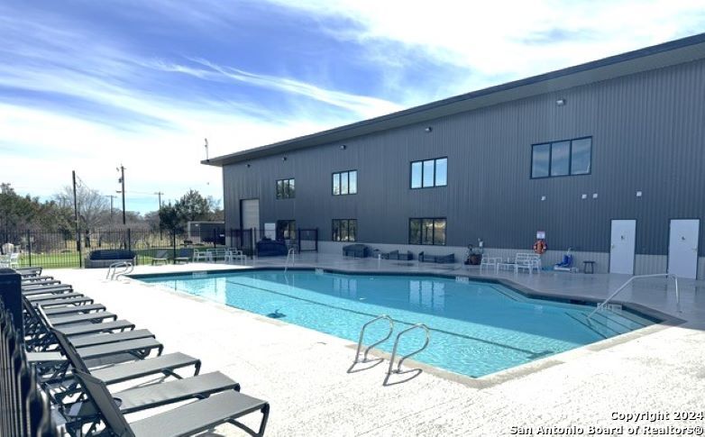 4300 Highway 16, Unit 29 Bandera, TX 78003 - Photo 5 of 10 a view of a swimming pool and lounge chairs