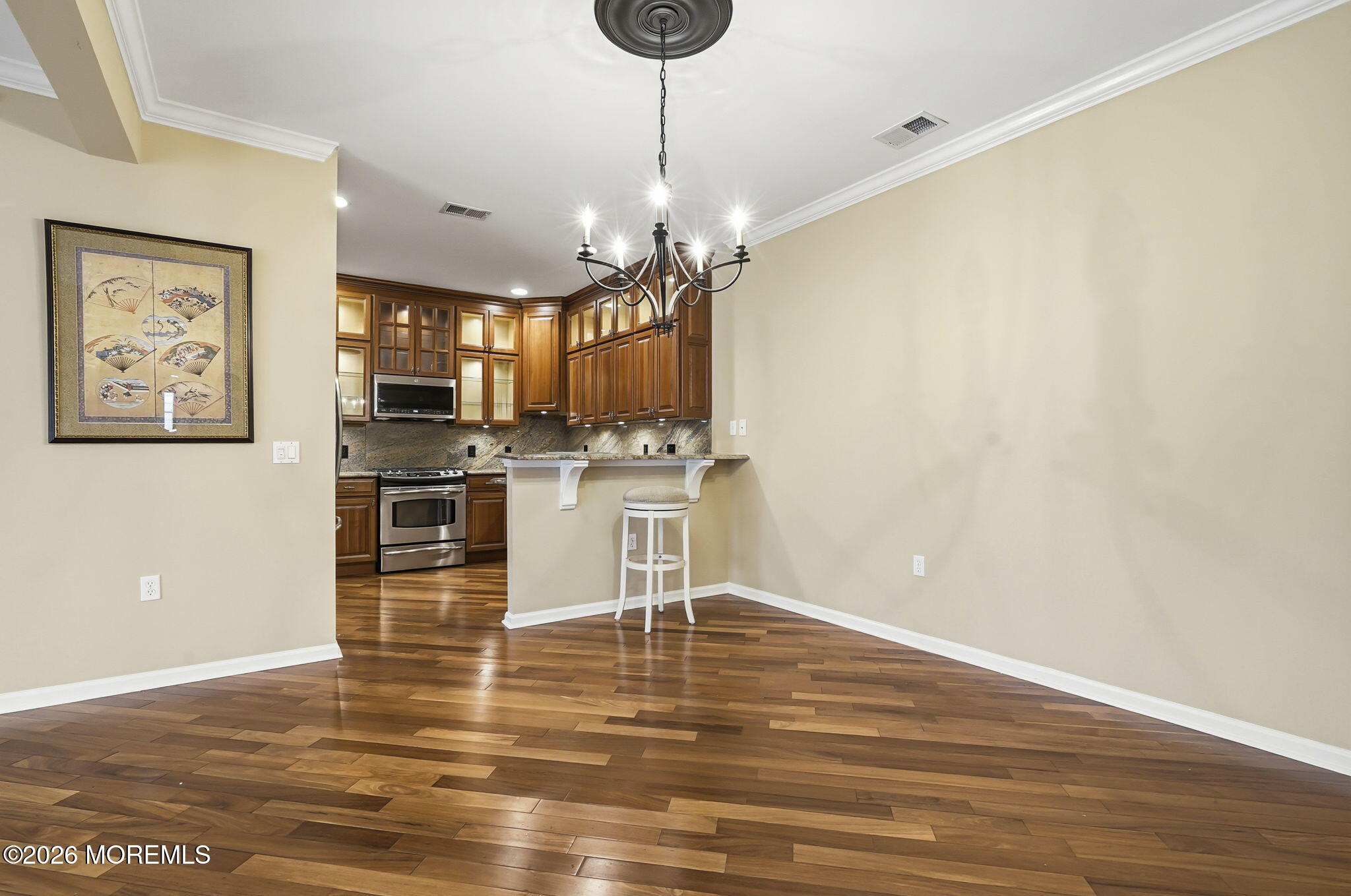 106 Potts Road Morganville, NJ 07751 - Photo 7 of 25 a kitchen with stainless steel appliances kitchen island granite countertop a stove a sink and a microwave