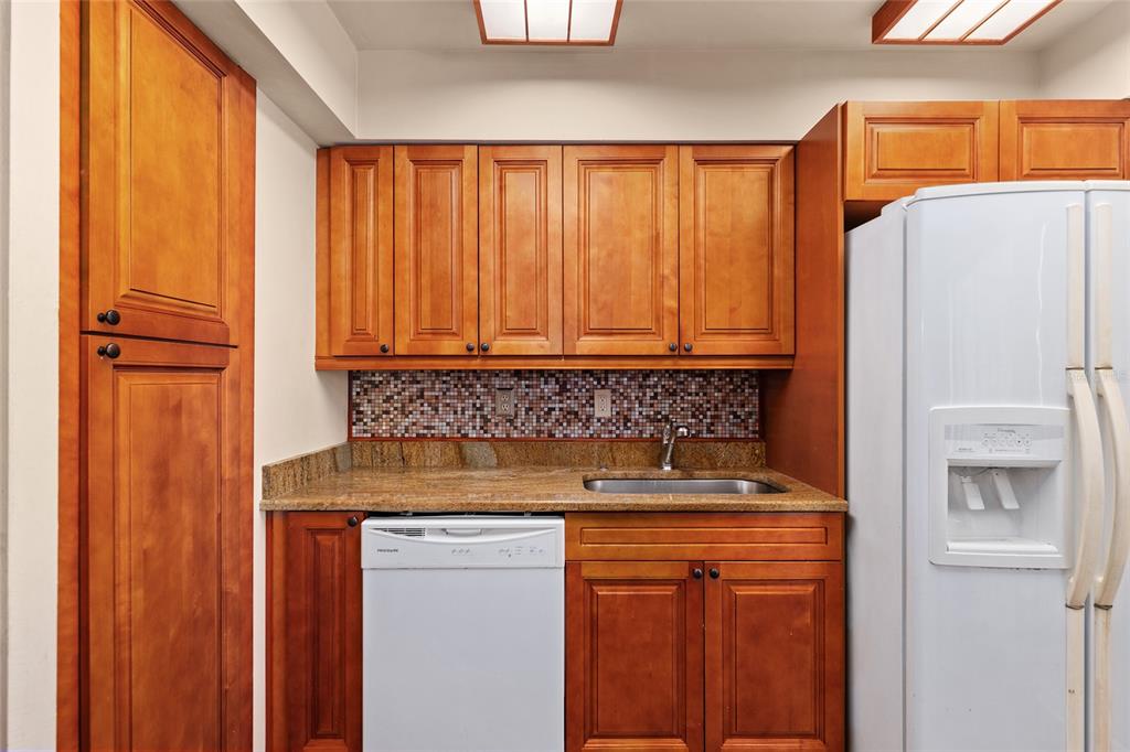 401 Northwest 39th Road, Unit 401C Gainesville, FL 32607 - Photo 13 of 62 a bathroom with a sink and a refrigerator